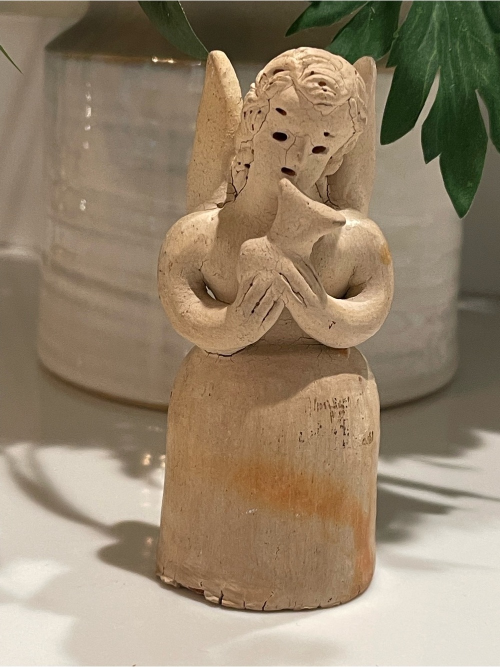 vintage primitive art pottery candle holder featuring an angel with a dove